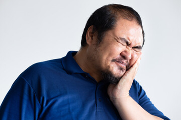 Obraz premium Middle aged old asian man suffering from toothache, tooth decay, tooth sensitivity, teeth grinding problem, oral health care concept