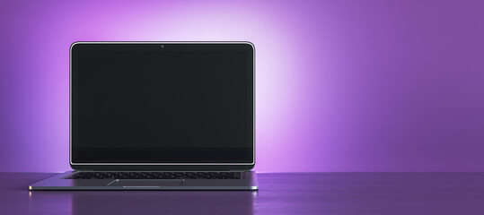 Creative purple designer workplace with empty black mock up laptop display. 3D Rendering.