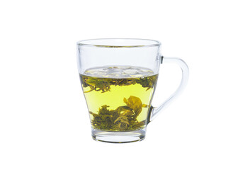 Green tea in a transparent glass cup. Water has just been added to a cup with green tea leaves.
