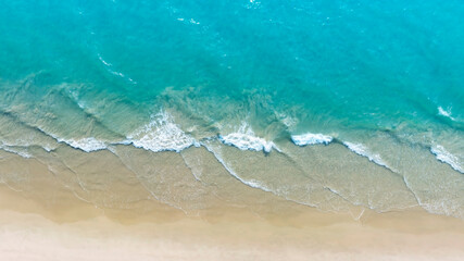 Aerial view with beach in wave of turquoise sea water shot, Top view of beautiful white sand background