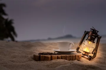 Küchenrückwand glas motiv Sonnenuntergang am Strand Close-up white coffee cup and many coffee beans placed around on the wood table with a beautiful seascape of nature background, concept coffee vacation travel, beautiful morning light background.