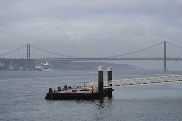Fototapeta premium Luxury liner cruiseship cruise ship Sirena, Regatta, Nautica or Insignia in port of Lisbon, Portugal during Mediterranean cruising with city skyline, Christos statue and suspension bridge