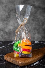 jellybean Gumballs in the form of slices of packed fruit on a dark background