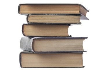 Fototapeta premium Worn spines of an old books. Books stacked on top of each other. On a white background.