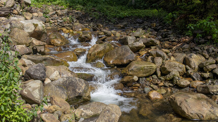 A narrow mountain river with rapids