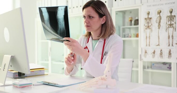 Doctor looking at x-ray with broken foot. Accident insurance concept
