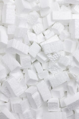 Texture formed by accumulation of regular shapes of white polystyrene.