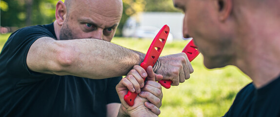 Knife attack self-defense. Techniques of disarming knife attacker. Weapon disarm training