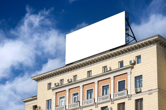 A large billboard on the roof of a historic building.