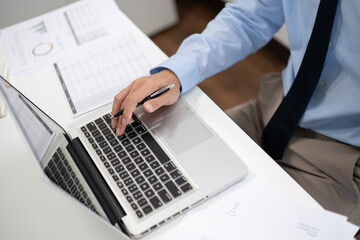 Business man working by using laptop computer Hands typing on a keyboard. Professional investor working new start up project. business planning in office. Technology business