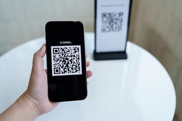 Qr code payment. E wallet. Man scanning tag accepted generate digital pay without money.scanning QR code online shopping cashless payment and verification technology concept.
