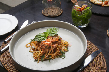 Portion of homemade spaghetti bolognese served in ceramic plate.	