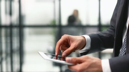 Midsection of businessman using digital tablet in office. - Powered by Adobe
