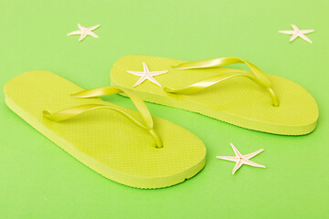 Beach accessories. Flip flops and starfish on colored background. Top view Mock up with copy space