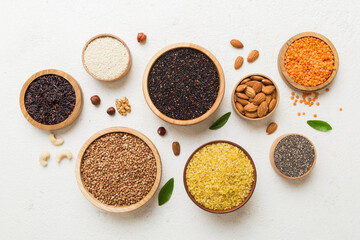 Various superfoods in smal bowl on colored background. Superfood as rice, chia, quinoa, lentils, nuts, sesame seeds, almonds. top view copy space