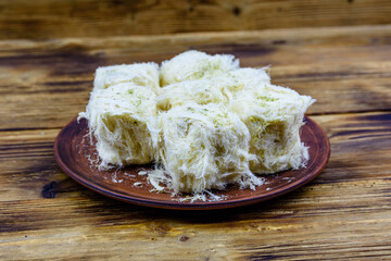 Traditional Turkish dessert Pismaniye on a wooden table