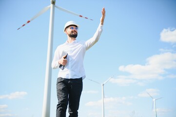 Engineer working at alternative renewable wind energy farm - Sustainable energy industry concept