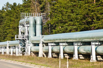 pipeline and road, forest and blue sky in the background