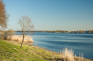 river bank in early spring against the blue sky