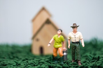 Close up of toys farmer people, cow’s milk bucket. They are going to milk the cows 