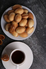 photo of a pile of cookies on a plate and a cup of coffee