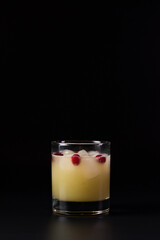 Winter cherry cocktail isolated on a black studio background