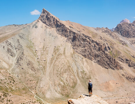 Hiker on rocky mountain background. Fann Mountains, Tajikistan, Central Asia