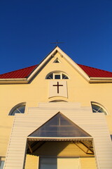 Protestant church with white walls against a blue sky
