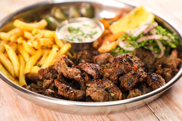Laham beef shawarma platter with fries and salad served in dish isolated on table top view fastfood