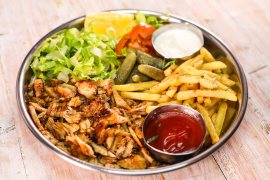Dajaj chicken Shawarma platter with fries and salad served in dish isolated on table top view fastfood