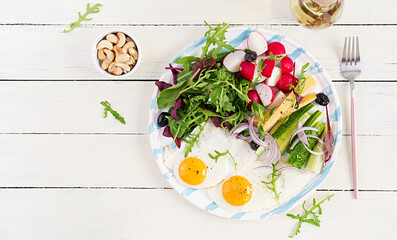 Ketogenic food. Fried egg, cheese, nuts and fresh salad. Keto, paleo breakfast. Top view, overhead, copy space