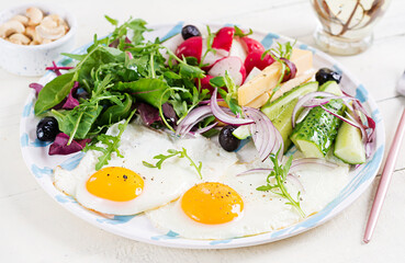 Ketogenic food. Fried egg, cheese, nuts and fresh salad. Keto, paleo breakfast.