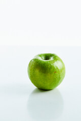 one green apple on a white background