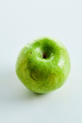 one green apple on a white background