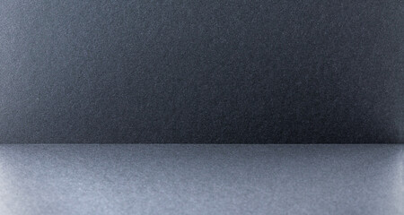 Dark gray and black abstract textured background.