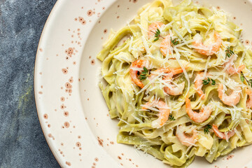 A plate of delicious shrimp alfredo with garlic and cream sauce over pasta. banner, menu, recipe place for text, top view