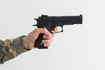 Military man holding a gun in hand