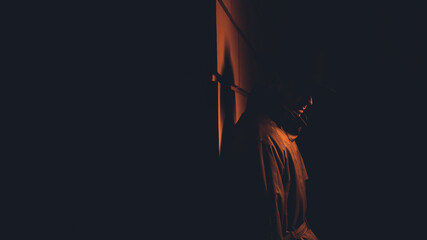 male mafia detective in a hat and raincoat at night in the style of film noir