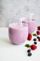 Cocktail with milk, ice cream and berries. On a white background. Deliciously