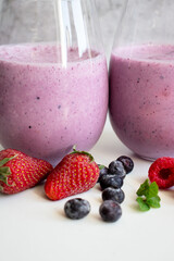 Cocktail with milk, ice cream and berries. On a white background. Deliciously