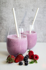 Cocktail with milk, ice cream and berries. On a white background. Deliciously