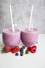 Cocktail with milk, ice cream and berries. On a white background. Deliciously