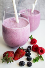 Cocktail with milk, ice cream and berries. On a white background. Deliciously