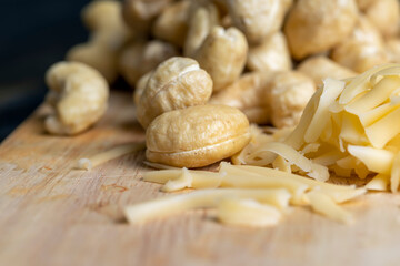 Sliced and grated hard cheese with cashew nuts