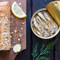 bread with seeds and sprat in the bank on a black background