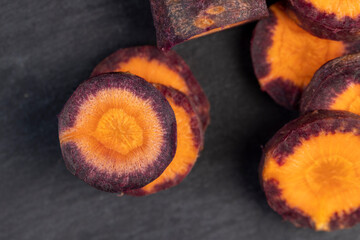 Pieces of sliced peeled carrots are red-orange in color