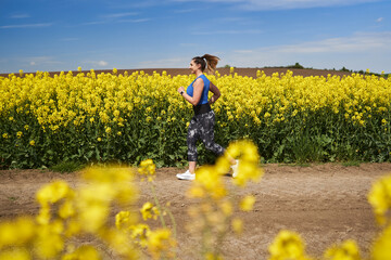 Plus size woman running on a countryside dirt road