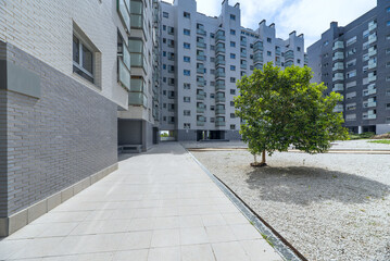Interior area of a residential development with gravel and young trees