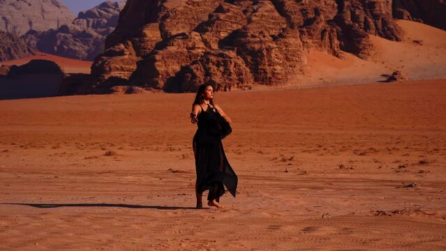 Traditional Young Woman Dancing In The Wadi Rum Desert, Jordan