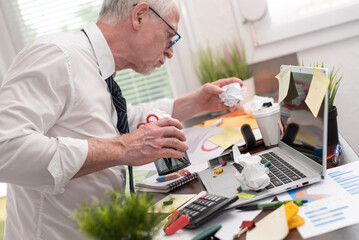 Disorganized businessman looking for documents